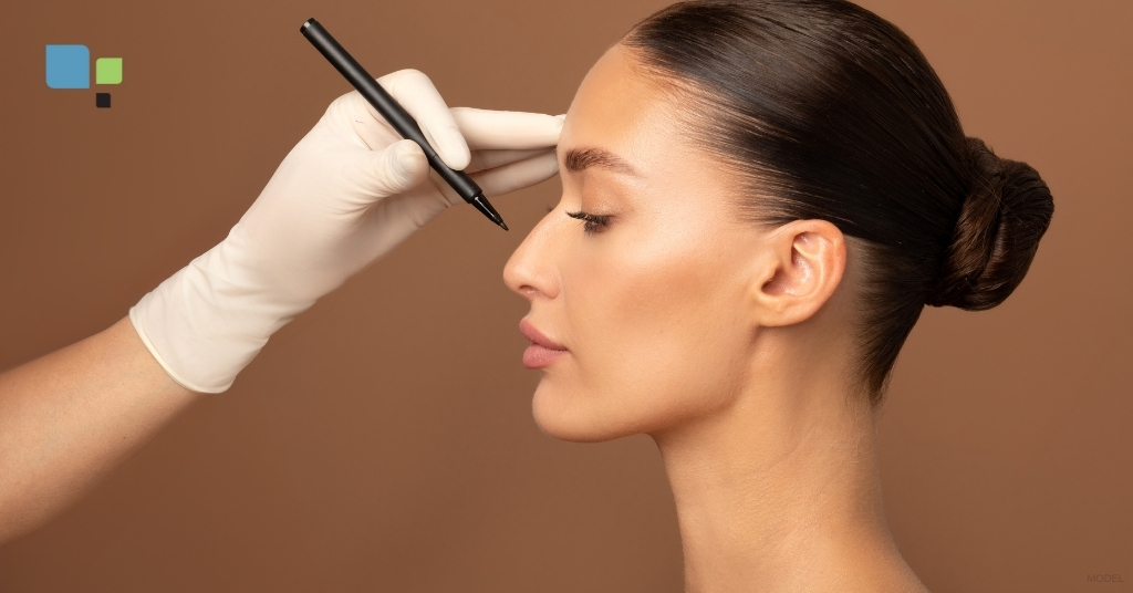 A healthcare professional marking a woman’s nose in preparation for rhinoplasty surgery. (MODEL) Primera Plastic Surgery Logo